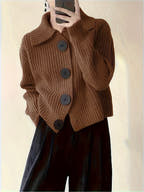 Brown knitted cardigan with buttons worn by a person, against a plain background